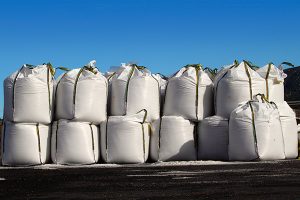 salt big bags sacks stacked rows for iced roads blue sky